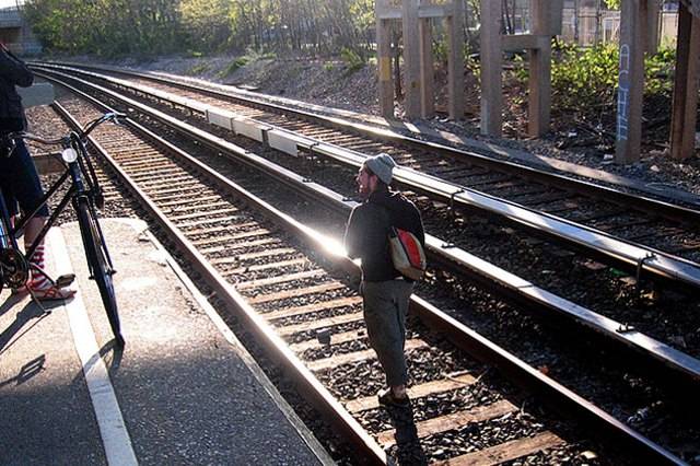 In this file photo, another unidentified jackass walks around on the Staten Island Railroad tracks, as if speeding trains are just fluttering butterflies put here on earth for our enchantment.
